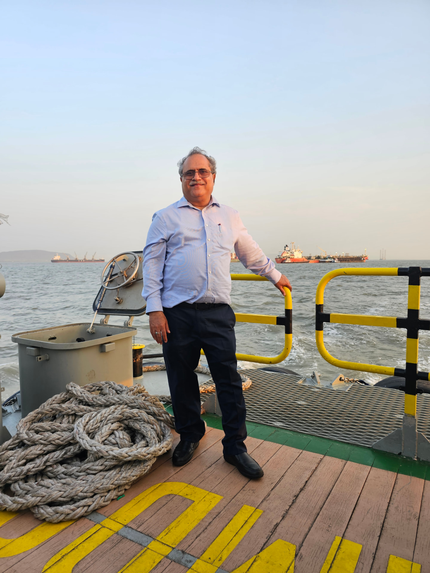 Adarsh Kumar Malpotra on an offshore vessel — energy sector consultant with 36+ years of ONGC leadership experience